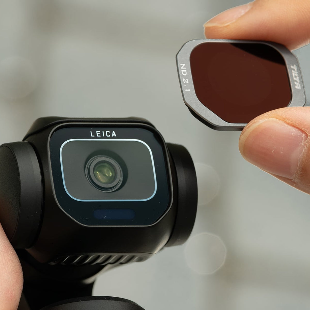 Tilta ND 2.1 filter being positioned for attachment over a Insta360 Luna Pro camera lens
